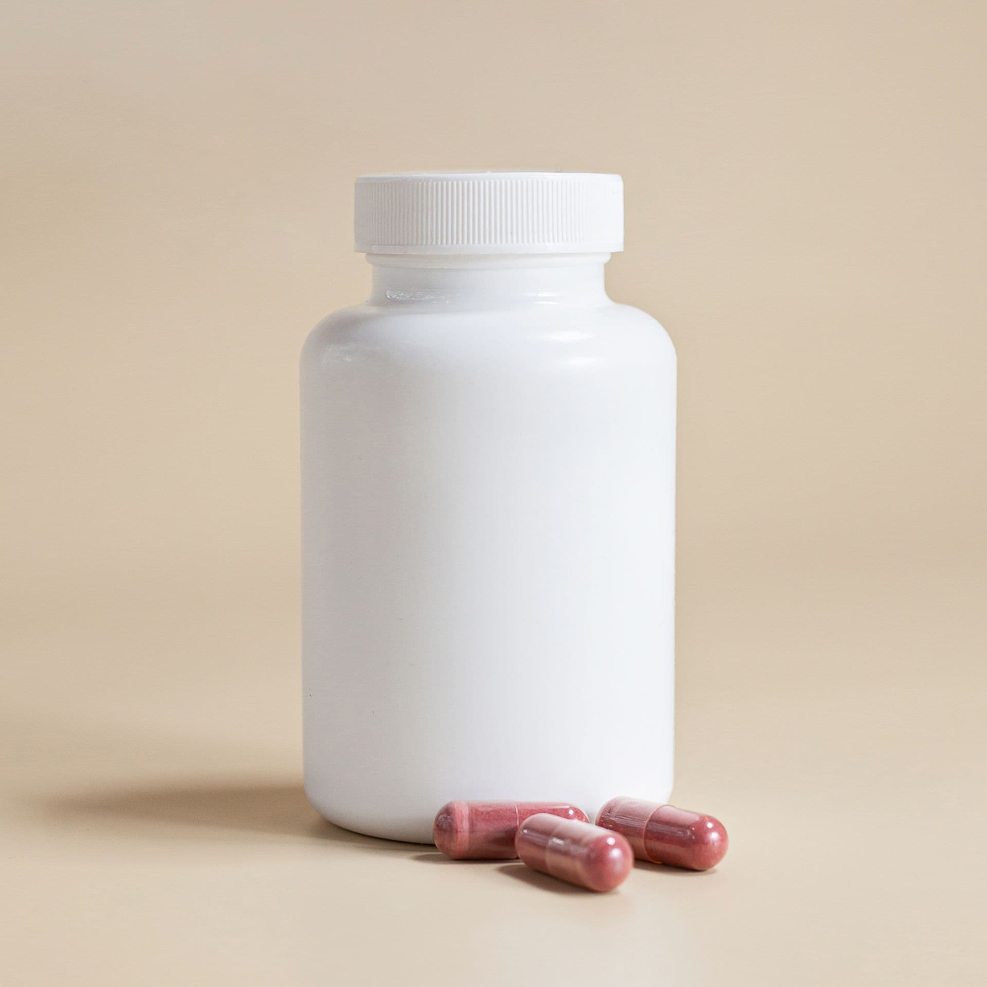 White pharmaceutical plastic bottle with capsules
