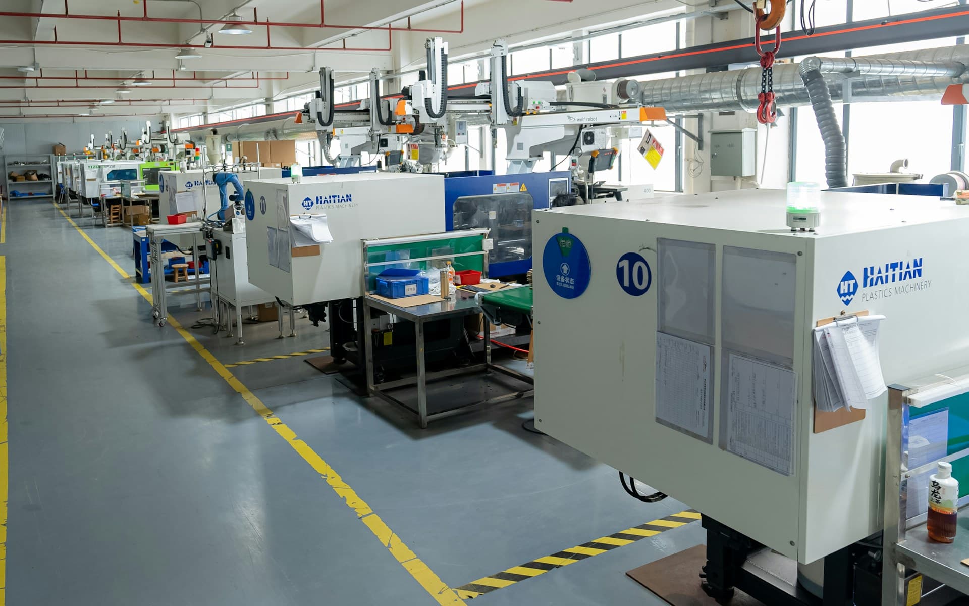 Injection moulding production line with automated plastic manufacturing equipment